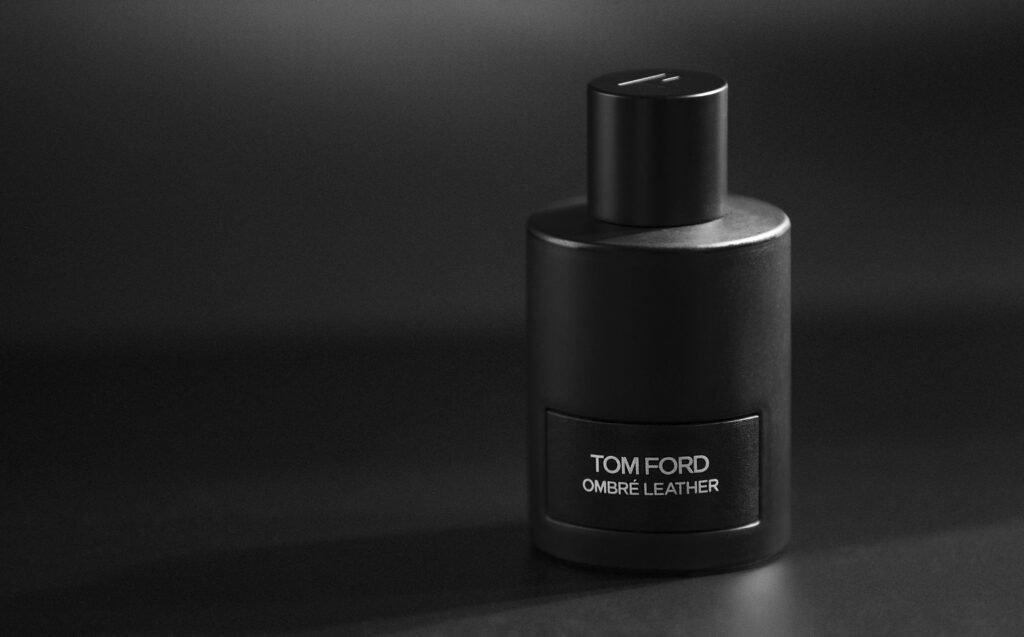 Elegant black Tom Ford Ombre Leather perfume bottle in studio lighting.